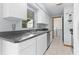 Modern kitchen with white cabinets and gray countertops at 11852 Se 71St Ct, Belleview, FL 34420