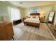 Bright bedroom with a wooden bed frame and a large window at 15025 Sw 24Th Cir, Ocala, FL 34473