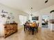 Charming dining room with a wooden table and view into a bedroom at 15025 Sw 24Th Cir, Ocala, FL 34473