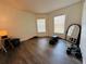 Bright room with laminate flooring, large windows, and space for fitness equipment at 15025 Sw 24Th Cir, Ocala, FL 34473