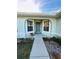 Inviting front entry with a walkway and landscaping at 15025 Sw 24Th Cir, Ocala, FL 34473