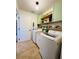 Bright laundry room with washer, dryer, and ample storage at 15025 Sw 24Th Cir, Ocala, FL 34473