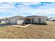 Single-story home with gray siding, attached garage, and landscaping at 1685 Ne 161St St, Citra, FL 32113