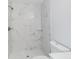 Large shower with marble tile and glass shelf at 17039 Sw 22 Terrace Rd, Ocala, FL 34473