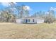 Newly built home with gray siding and a blue door at 24440 Nw Falcon Ave, Dunnellon, FL 34431