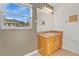 Clean bathroom with wood vanity and large window at 3648 Sw 131St Place Rd, Ocala, FL 34473