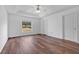 Bedroom with wood-look floors, window, and ceiling fan at 3648 Sw 131St Place Rd, Ocala, FL 34473