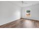 Spacious bedroom with wood-look flooring and window at 3648 Sw 131St Place Rd, Ocala, FL 34473