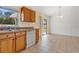 Kitchen features wood cabinets, white appliances, and tile floor at 3648 Sw 131St Place Rd, Ocala, FL 34473