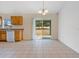 Bright kitchen with wood cabinets, tile floor, and access to backyard at 3648 Sw 131St Place Rd, Ocala, FL 34473