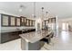 Modern kitchen with dark cabinetry, granite counters, and island seating at 4812 Se 37Th St, Ocala, FL 34480