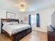 King-size bed, dresser, and TV in a bright bedroom at 5032 Se 108Th St, Belleview, FL 34420