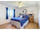 Cozy bedroom with a full-size bed and wood furniture at 5032 Se 108Th St, Belleview, FL 34420