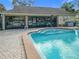 Inviting community pool with brick patio and surrounding building at 5032 Se 108Th St, Belleview, FL 34420