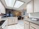 Open kitchen with white cabinets, view of living room and dining area at 5032 Se 108Th St, Belleview, FL 34420