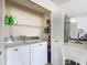 Neat laundry room with washer, dryer, and storage shelves at 5032 Se 108Th St, Belleview, FL 34420