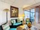 Living room with teal couch and wicker chairs, access to patio at 5032 Se 108Th St, Belleview, FL 34420
