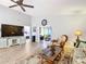 Bright living room with hardwood floors, large TV, and comfortable seating at 5032 Se 108Th St, Belleview, FL 34420