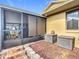 Outdoor screened patio with tiled flooring and storage space at 5032 Se 108Th St, Belleview, FL 34420