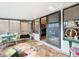 Relaxing screened patio with tiled floor, seating area, and access to interior at 5032 Se 108Th St, Belleview, FL 34420