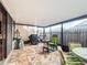 Outdoor patio with seating area, grill, and screened enclosure at 5032 Se 108Th St, Belleview, FL 34420