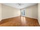 Bright bedroom featuring wood-look flooring and sliding glass doors at 505 Kempton Pl, The Villages, FL 32162