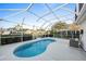 Relaxing kidney-shaped pool with screened enclosure at 505 Kempton Pl, The Villages, FL 32162