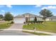 One-story home with stone accents, landscaping, and a two-car garage at 6407 Sw 45Th Ave, Ocala, FL 34474