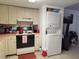Galley kitchen with washer and dryer at 8178 Fairways Cir # U201, Ocala, FL 34472