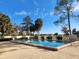 Community pool with surrounding trees at 8178 Fairways Cir # U201, Ocala, FL 34472
