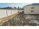 Backyard view showing a home's exterior and a white vinyl fence at 8457 Sw 138Th Pl, Ocala, FL 34473
