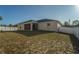 House's back exterior and yard with a white vinyl fence at 8457 Sw 138Th Pl, Ocala, FL 34473
