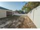Large backyard with white vinyl fence and mature trees at 8457 Sw 138Th Pl, Ocala, FL 34473