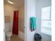 Bathroom with a toilet, bathtub, and a red shower curtain at 8457 Sw 138Th Pl, Ocala, FL 34473