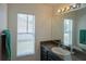 Bathroom with granite countertop, sink, and large mirror at 8457 Sw 138Th Pl, Ocala, FL 34473
