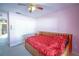 Spacious bedroom with double doors to closet and a day bed at 8457 Sw 138Th Pl, Ocala, FL 34473