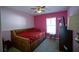 Cozy bedroom with a daybed, ceiling fan, and pink walls at 8457 Sw 138Th Pl, Ocala, FL 34473