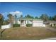 Single-story house with a green roof, attached garage, and a well-maintained lawn at 8457 Sw 138Th Pl, Ocala, FL 34473