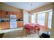 Kitchen with wood cabinets, white appliances, and a breakfast nook at 8457 Sw 138Th Pl, Ocala, FL 34473