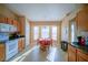 Kitchen boasts wood cabinets, white appliances, and a corner breakfast area at 8457 Sw 138Th Pl, Ocala, FL 34473