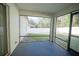 Screened-in porch with dark tile flooring and backyard view at 8457 Sw 138Th Pl, Ocala, FL 34473