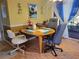 Charming dining area with a wood table and four chairs, near a sliding glass door at 8473 Sw 106Th St, Ocala, FL 34481