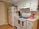 White kitchen with full-size appliances and ample counter space at 8473 Sw 106Th St, Ocala, FL 34481