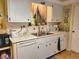 White kitchen with ample cabinetry, stainless steel appliances, and a double sink at 8473 Sw 106Th St, Ocala, FL 34481