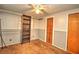 Bedroom with brown carpet, built-in shelving and closet at 10655 Ne 224Th Place Rd, Fort Mc Coy, FL 32134