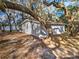 Cozy lakefront cottage exterior, nestled amongst mature trees at 10655 Ne 224Th Place Rd, Fort Mc Coy, FL 32134