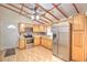 Open kitchen with stainless steel appliances and wood cabinets at 10655 Ne 224Th Place Rd, Fort Mc Coy, FL 32134