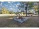 Large backyard with fire pit and mature trees at 11360 Se 188Th Ave, Ocklawaha, FL 32179