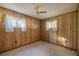 Bedroom with wood paneling walls and carpeted floor at 11360 Se 188Th Ave, Ocklawaha, FL 32179
