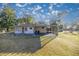 Single story home with carport, yard, and mature trees at 11360 Se 188Th Ave, Ocklawaha, FL 32179